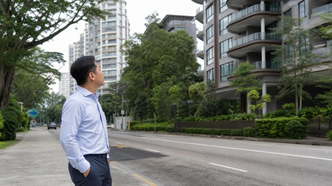 A property investor studies Singapore’s evolving landscape, land values, and residential investment opportunities.